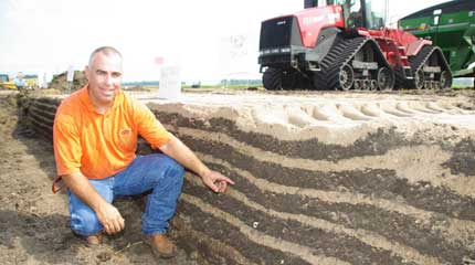 Feature Image Man crouching next to a set of soil layers