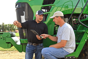 Agronomist and grower review field data near field equipment