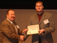 North Central Branch President Steve Paszkiewicz with 1st Place Crops Poster Winner Terry J. Schulz.
