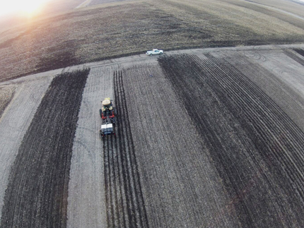 Vista aérea del equipo tractor y labranza en campo.