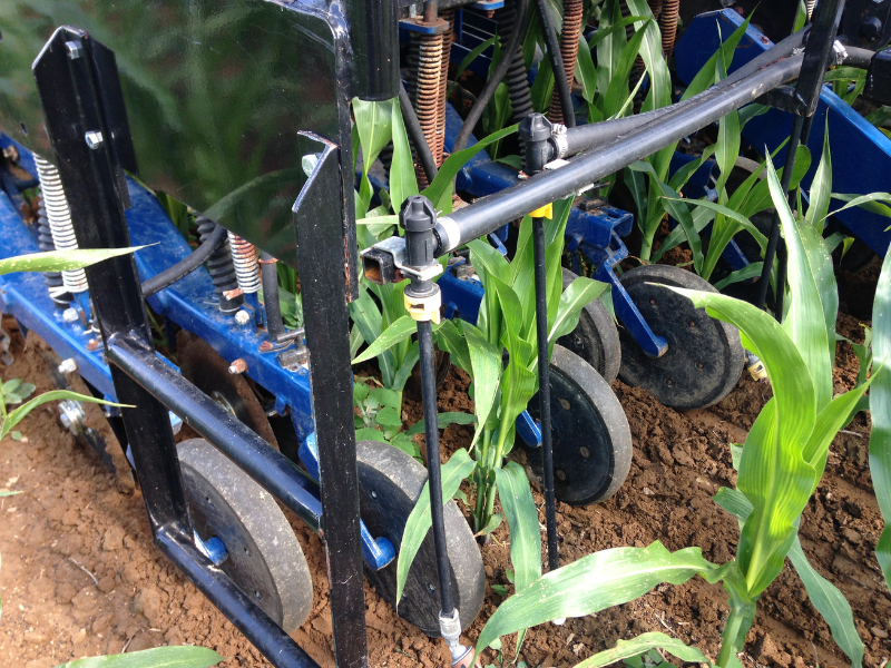 closeup of InterSeeder tool sowing cover crops on ground