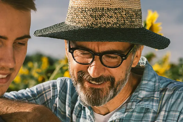 Two people in field of sunflowers